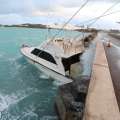 Photos: Boat Resting Against Causeway Wall