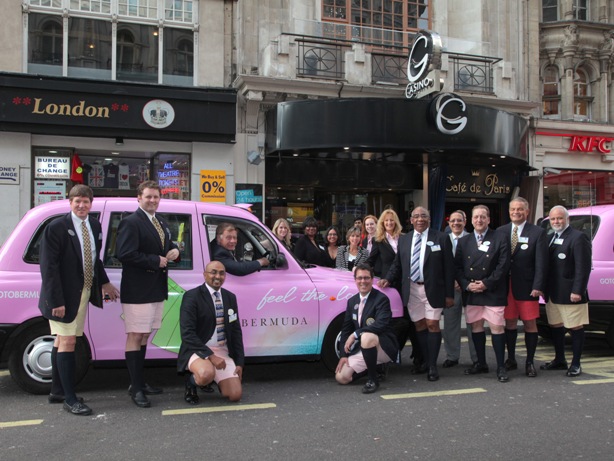 The Bermuda Delegates alongside a Bermuda Pink London Taxi