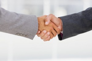 Businesspeople shaking hands together