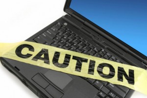 computer fraud laptop caution sign